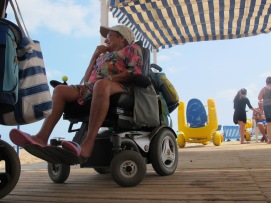 The wheel chair doesn't stop them from enjoying the sea. 